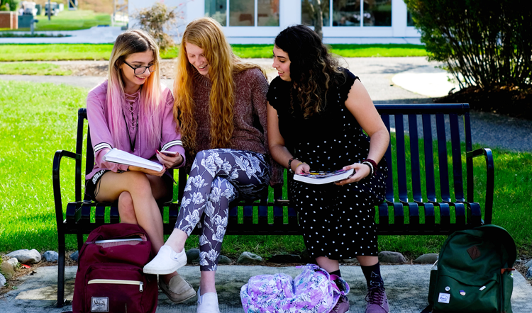 qqzhangui.com three female students studying on a bench on camp at Ocean County College